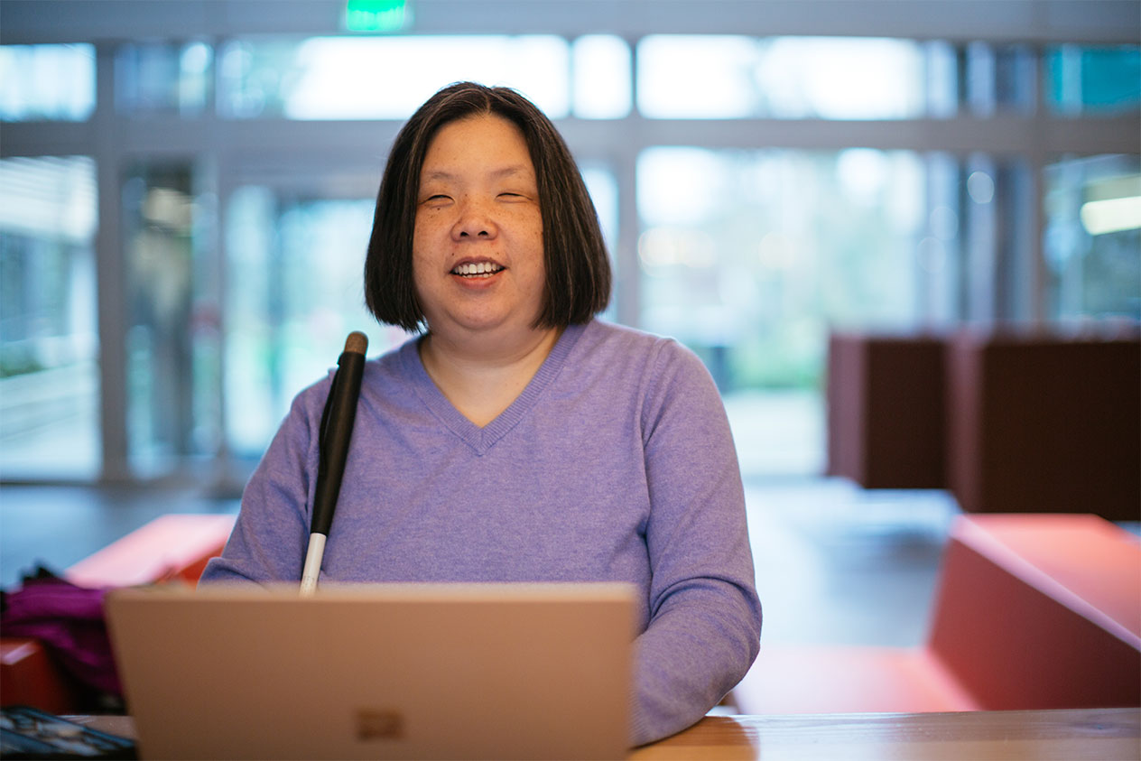 Anne, a nonsighted person, uses an assistive device with her laptop